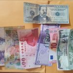 Paper money of countries all over the world with one fake bill