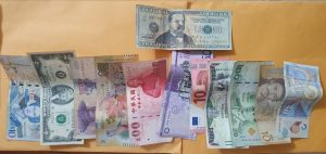 Paper money of countries all over the world with one fake bill